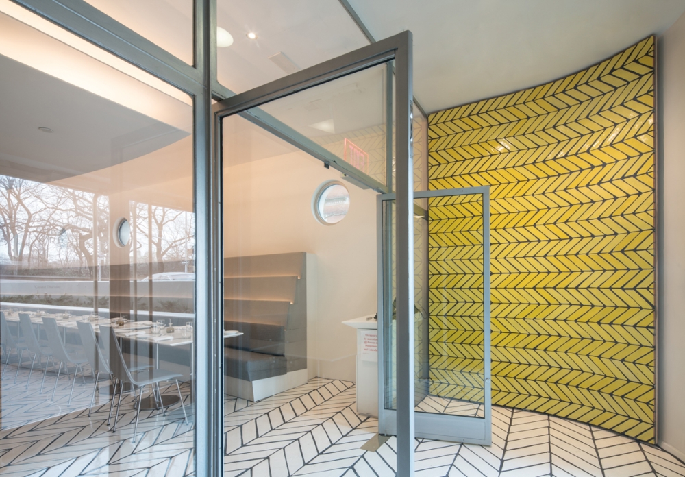a restaurant with yellow tiled walls