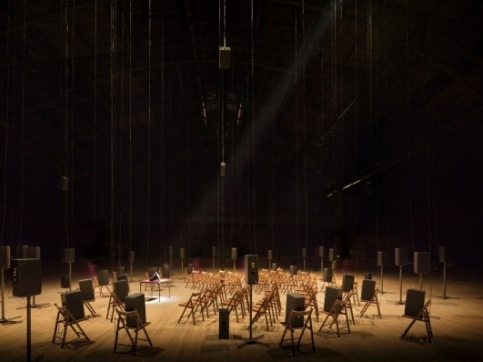 Chairs arranged in a circle facing a speaker
