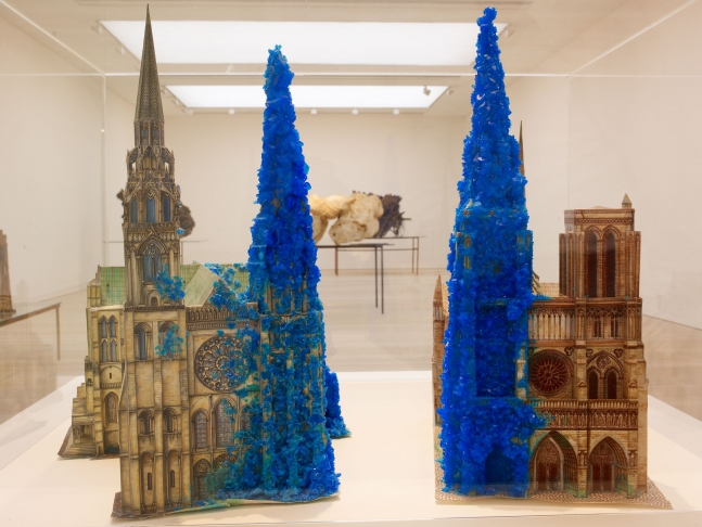 Roger Hiorns
Copper Sulphate Chartres &amp;amp; Copper Sulphate Notre-Dame, 1996
Card constructions with copper sulphate chemical growth; mounted on glass and wood trestle table with Perspex cover underlit by two strip lights
54 x 44 1/4 x 25 2/3 inches
(137 x 125 x 65 cm)
Installation view in&amp;nbsp;The Shape of Things to Come: New Sculpture
May 27 &amp;ndash; October 16, 2011
Saatchi Gallery, London
