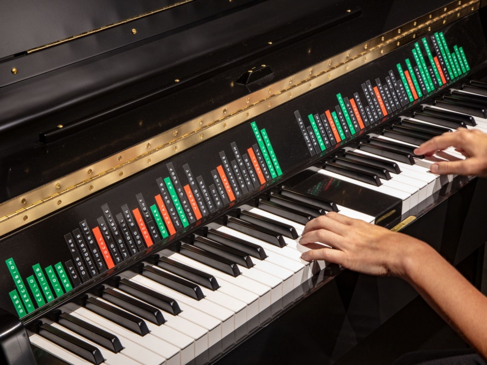 Hands playing an organ keyboard