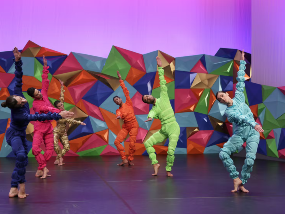 6 dancers performing on a colorful, geometric stage