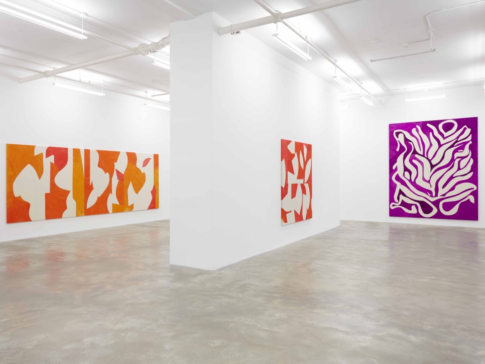 3 geometric abstract paintings in a gallery space 
