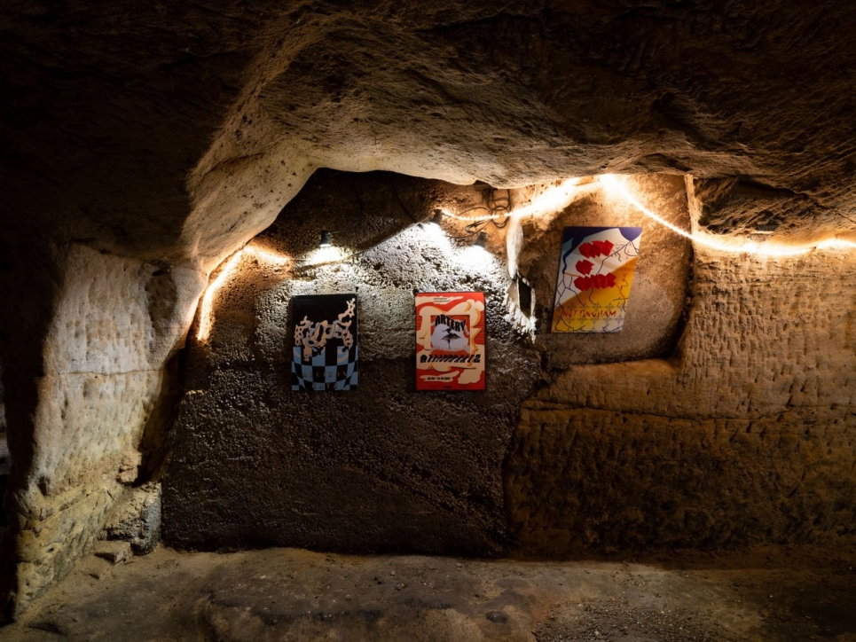 Katz poster installation in cave